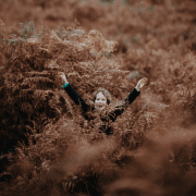 Project Wild Thing - Kid standing in tall bracken. Photo credit: Annie Spratt