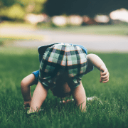 Toddler inspecting lawn to rrflect strategies that inspire curiosity. Photo credit: Jordan Whitt