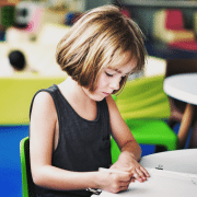 School girl writing at desk, reflecting different learning styles. Photo credit: Pan Xioazhen