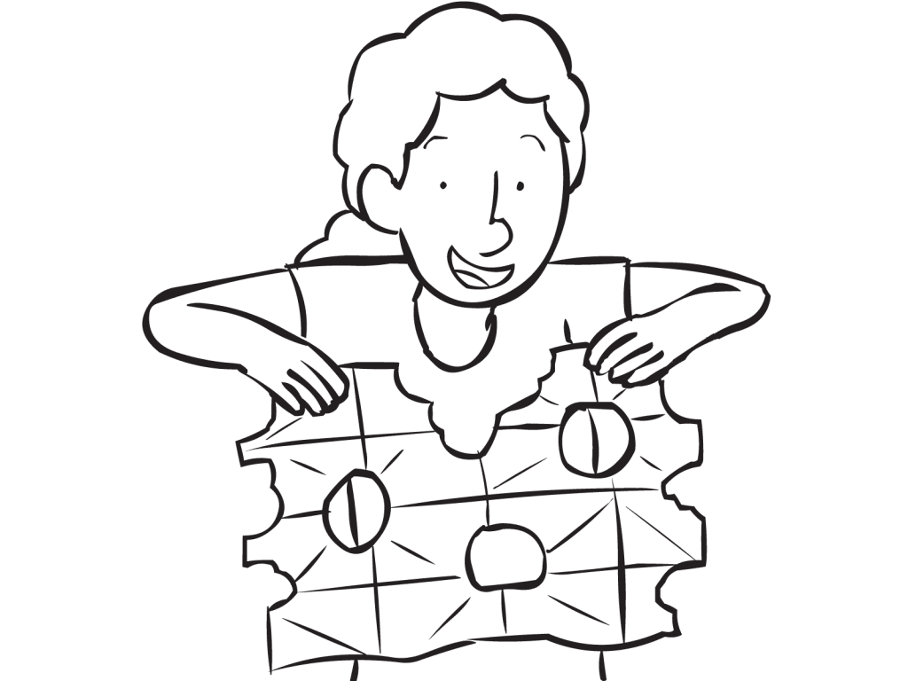 Person unfolding sheet of paper which has holes torn out of it as seen in communication team-building activity Snowflake