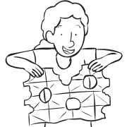 Person unfolding sheet of paper which has holes torn out of it as seen in communication team-building activity Snowflake