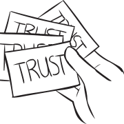 Hand holding bunch of index cards with TRUST written on them, as seen in interactive values exercise called Values Stock Market