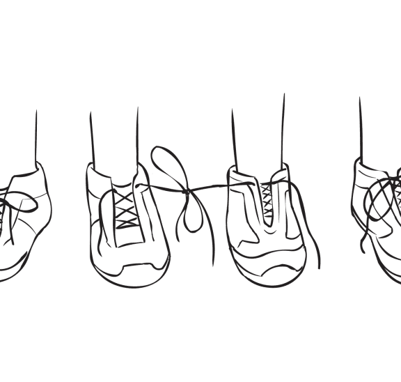 Two pairs of shoes with laces of two shoes tied together, as featured in creative partner exercise called Tiny Teach