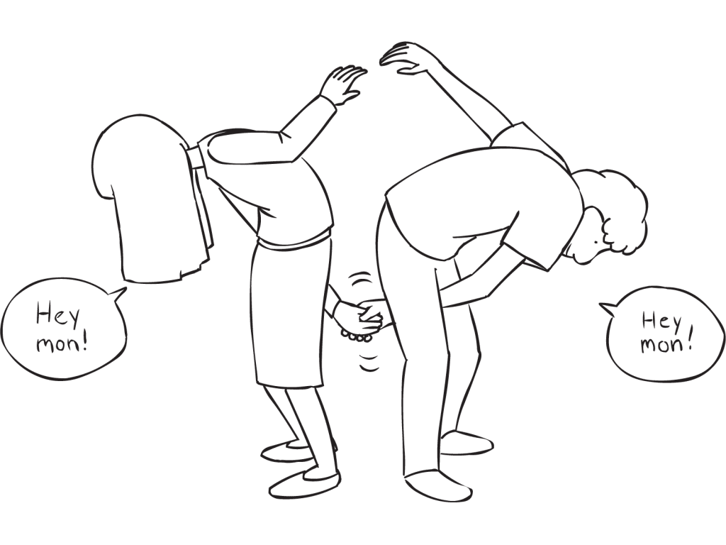 Two people shaking hands through their legs as part of interactive icebreaker activity Partner Greetings