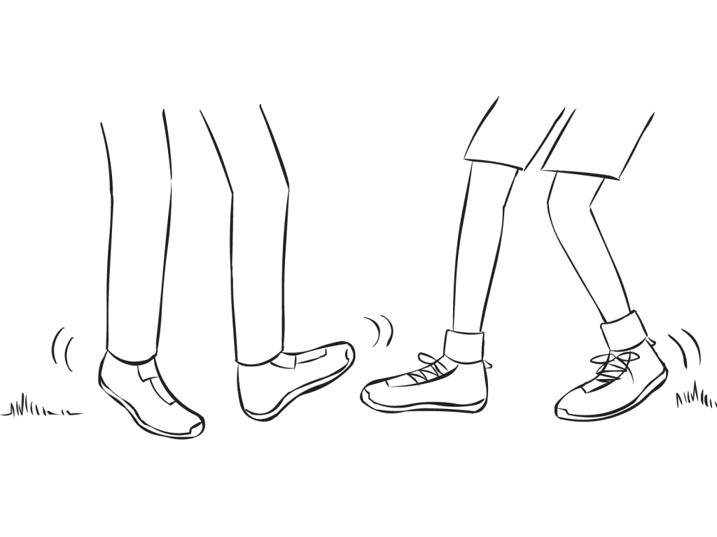 Two people trying to tag each others feet in quick partner tag game called Toe Tag game