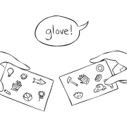 Hands holding two Ubuntu Cards looking for matching objects as connection-building activity