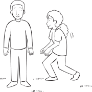 Woman creeping up to man with his eyes shut in trust-building activity called Come To Me