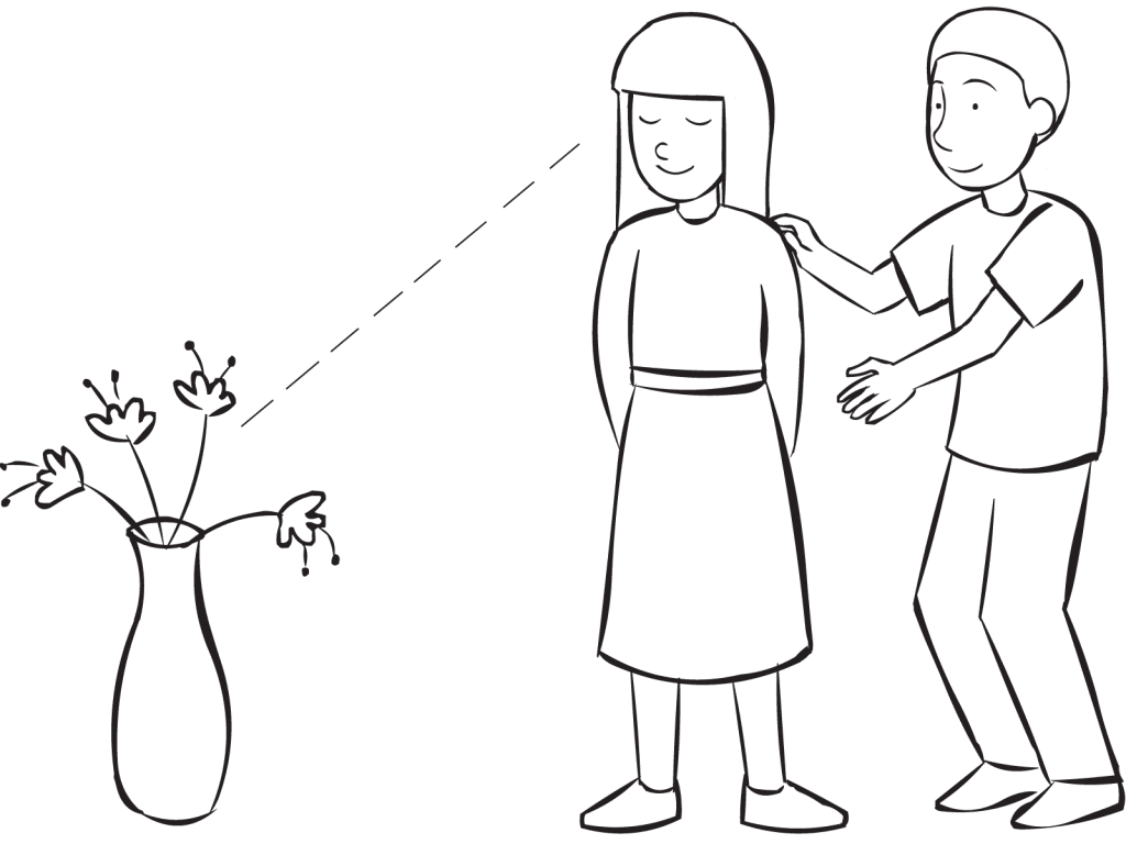 One person guiding another to look at a vase, as part of the fun partner trust exercise Human Camera