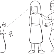 One person guiding another to look at a vase, as part of the fun partner trust exercise Human Camera