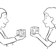 Two people showing a wooden block they are holding and sharing as part of interactive icebreaker game Mingle and Match