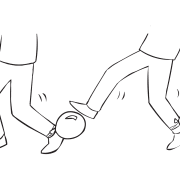 Person attempting to stand on the balloon tied to partner's ankle, in fun energiser called Balloon Tag game