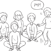 Group of people jumping up and down as part of group energiser game Popping Corn