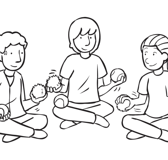 Three people sitting in circle passing balls to each other quickly as featured in circle passing game Quick Pass