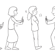 Two lines of people facing one another in a straight line with one person rocking back and forth between the two middle spotters as part of the trust line powerful trust-building activity