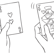 Two people holding two different playing cards as seen in simple icebreaker activity Playing Card Mixers