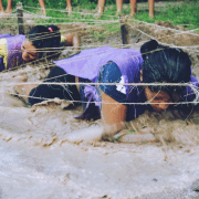 Honouring Challenge by Choice - two women completing a mud crawl