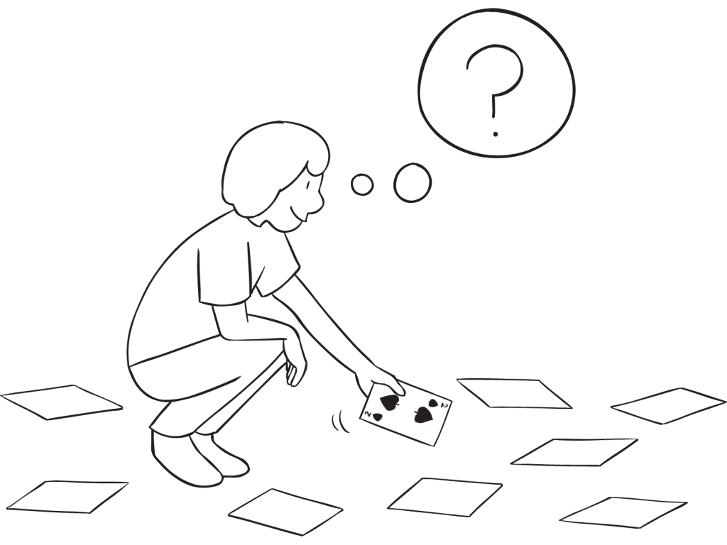 Person bending down picking up card playing Over There group continuous improvement activity