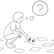 Person bending down picking up card playing Over There group continuous improvement activity