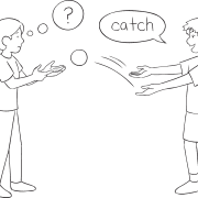 Two pleople passing a ball as part of Push Catch quick reaction game