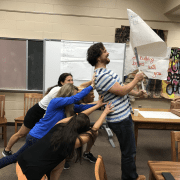 Teachers holding flag working to set behavioural norms