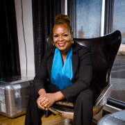 Female manager sitting in office chair considering management team building activity ideas