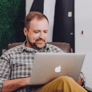 Man using laptop at home playing virtual trust building activities