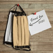 Goodbye 2020 note with face masksreflecting on year in numbers