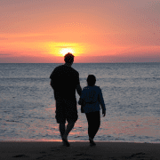Father & child programs on the beach at sunset. Credit Emotionary App
