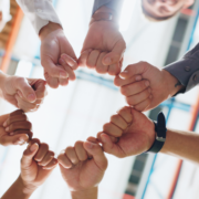 Small group team-building circle of fists