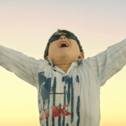 Boy with arms outstretched wide with instant energy