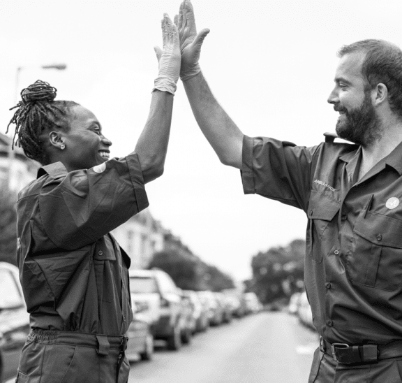 Look for the helpers, man and woman doing high-five. Credit rawpixel