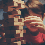 Boy playing with Jenga with curiosity, necessary for human mind to flourish. Photo credit: Michal Parzuchowski