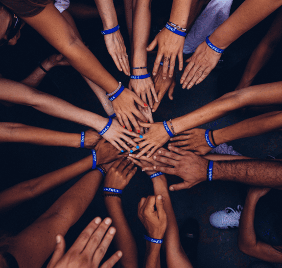 Circle of hands showing power of learning together. Credit Perry Grone