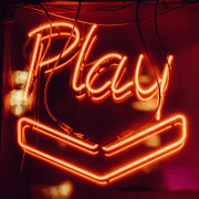 Neon sign displaying definition of play. Photo credit: Clem Onojeghuo