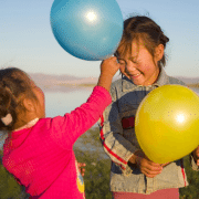 More play with two girls playing with balloons