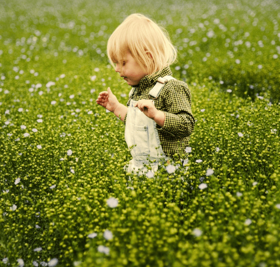 Girl in meadow, enjoying notion of get kids to play outdoors