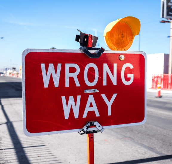 Wrong Way Go Back sign to reflect that team-building is crap. Photo credit: Neonbrand