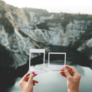Framing is key as depicted by a person holding two different frames up against a mountain backdrop
