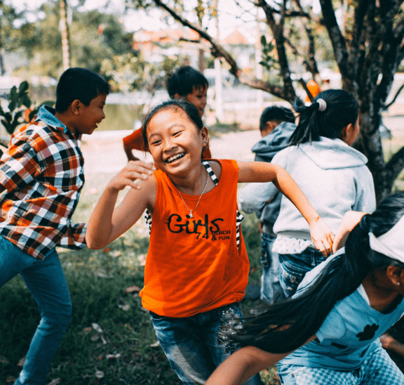 Girl running in group, showing key elements of play. Credit Mi Pham