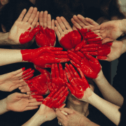 How to connect with others, heart painted on hands. Credit Tim Marshall