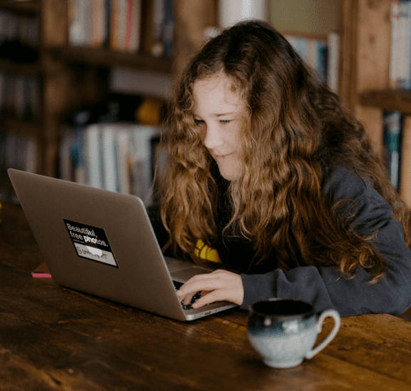 Student at computer playing games for 1, 2 or 3 people