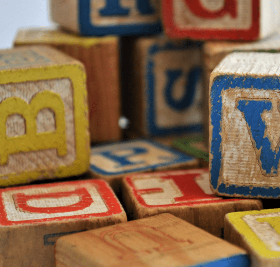 Wooden toy blocks offering inclusive language