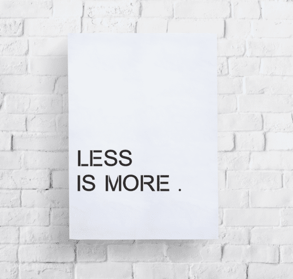 Less is more poster on brick wall for Homesteading Quotes.