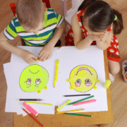 Children drawing emoji faces as part of SEL course