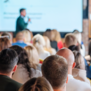 Large audience sitting down waiting for quick and fun energiser