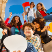 Teenagers holding talkee bubble signs about engaging debriefing activities