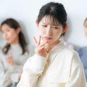 Asian woman being excluded from clique wondering how to break up cliques
