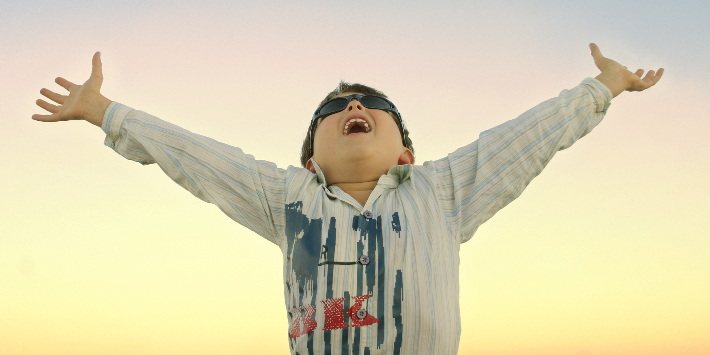 Boy with arms outstretched wide with instant energy